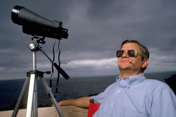 Novelist Tom Clancy with tripod mounted binoculars 2331194